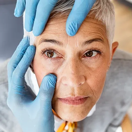 A practitioner examining a patient's eye