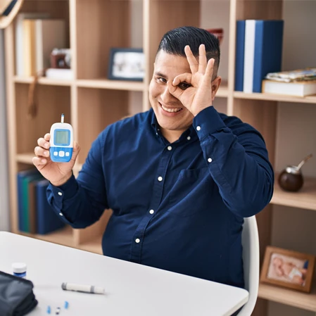A diabetic patient holding a glucometer
